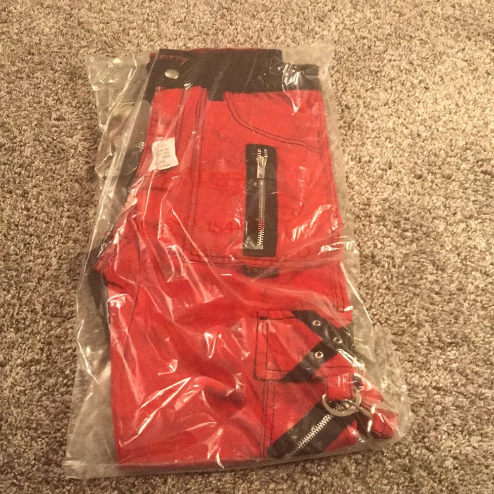 Brand new Tripp bondage pants, split dye red/black. Size 28/7